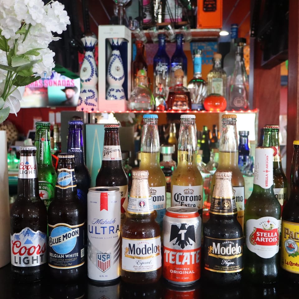 Selection of bottled and canned beers displayed at the restaurant bar.
